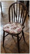 A set of four beech hoop back dining chairs with solid seats on turned legs with stretchers (four