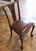 A set of four mahogany Georgian style dining chairs with pierced splats, upholstered drop in