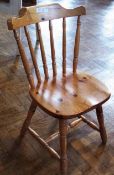 A pair of modern pine single chairs with turned splat backs, solid seats, on turned legs united by