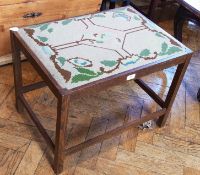 An oak rectangular top stool, with drop-in upholstered needlework seat, on square legs united by