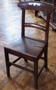 A nineteenth century single cottage chair, with shaped bar back, solid seat, on square tapering legs