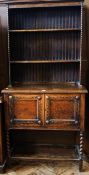 Twentieth century Jacobean style oak dresser with two shelf open plate rack, pair of carved panel