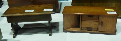 An oak miniature musical box in the form of a refectory table, with rising lid and a miniature model