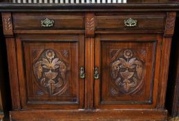 Victorian walnut dresser base, with two frieze drawers and a pair of carved panelled doors below