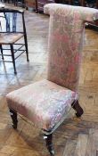 A William IV rosewood prie dieu chair, with floral upholstery on carved lotus petal turned legs with