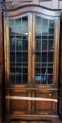 Twentieth century oak glazed bookcase, the arch top above a pair of glazed leaded light doors