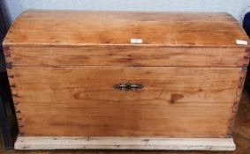 A Victorian pine dome-top trunk, the interior fitted with trinket box, iron carrying handles, raised