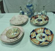 Two Imari porcelain plates, a set of five porcelain serving dishes with pink glaze and bird