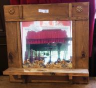 An old pine decorative wall mirror, the rectangular plate with pressed flower decoration and shelf