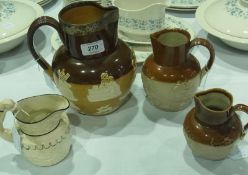 A Doulton Lambeth Harvest jug, with a silver rim, with two further smaller Harvest jugs and a