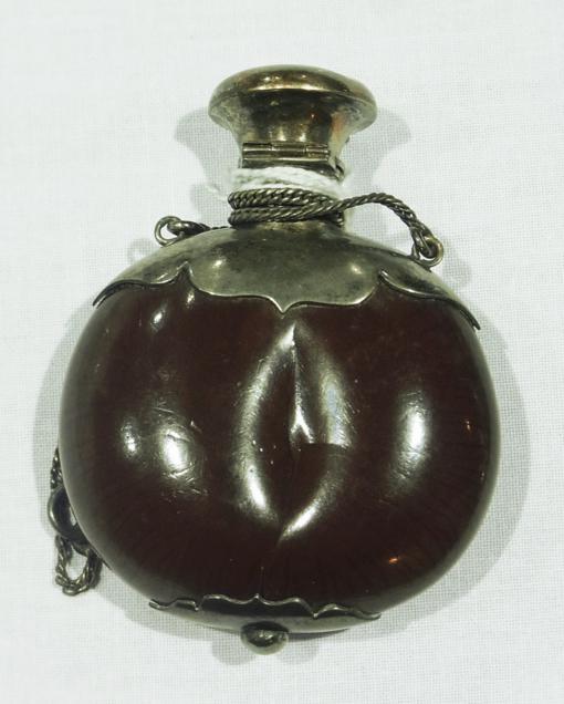 Foreign silver coloured mounted seedpod scent bottle, possibly sea bean on fine chain