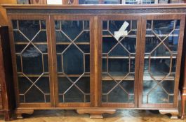 Georgian style mahogany glazed bookcase, with lion fretwork frieze, the two pairs of astragal glazed