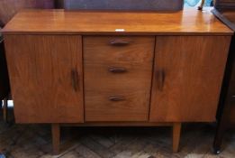 Circa 1960 hardwood sideboard with three central short drawers flanked by a pair of cupboards