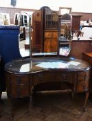 Early twentieth century walnut veneer kidney shaped triple mirror back dressing table with plate