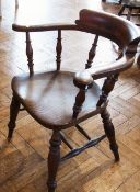 A Victorian smoker's chair with turned spindle back, solid elm seat on turned legs united by