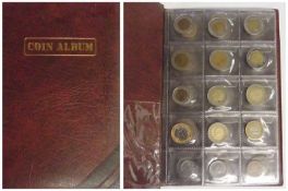 Accumulation of coins of the world in album, including Turkey and Brazil