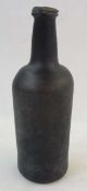 Eighteenth century/nineteenth century brown glass bottle, with string rim to top, 24cm tall