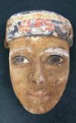 An Egyptian antiquity wooden painted mask with some original pigment W 14 H 18 cm