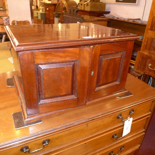 A late C19th mahogany table top collectors cabinet having a pair of panelled doors and a brass