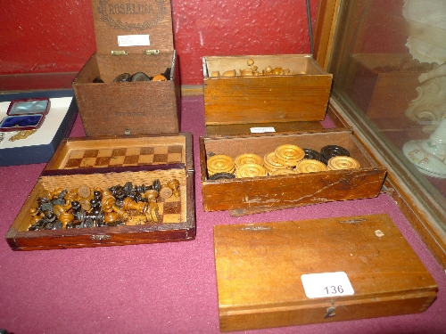 Three boxed sets of chess with boxwood pieces together with draughts and a set of small carved