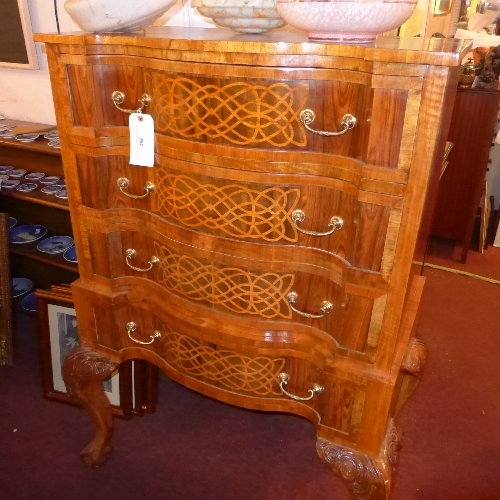 A Continental walnut and satinwood inlaid chest on stand of serpentine outline fitted four drawers
