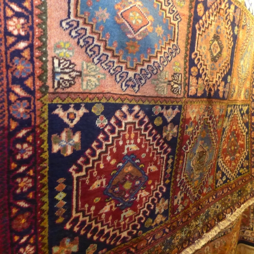A fine North West Persian Yallemeh rug with repeating panel motifs on an ivory field within