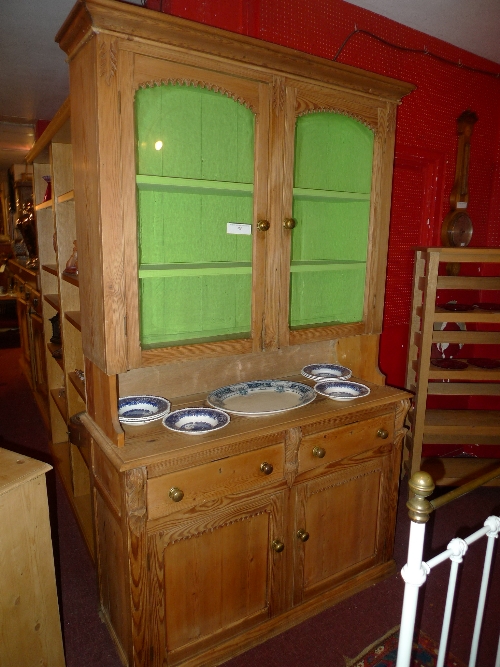 An antique pine dresser with pair of glazed panel doors over pair cupboard doors W 128 x D 50 x H