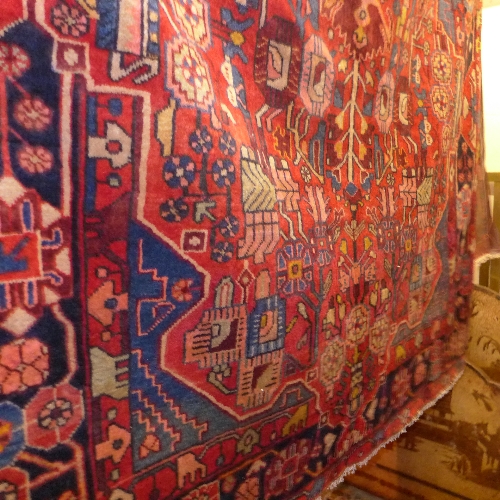 An extremely fine North West Persian Nahawand rug with central pole medallion on a rouge field