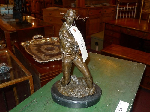 A bronze of a fisherman on marble base H 40 cm