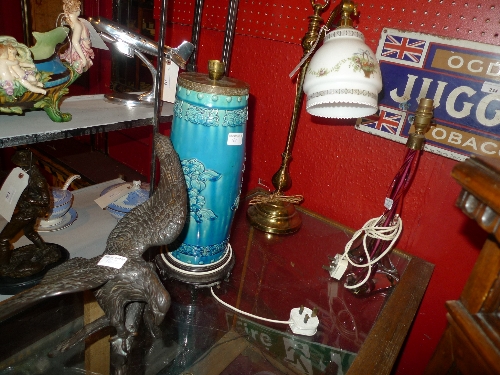 A brass desk lamp of adjustable form with opaque glass shade, a blue pottery similar together with