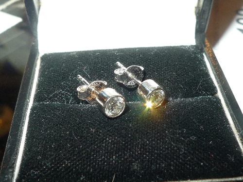 A pair of 18ct white gold earrings with .50ct diamond insets