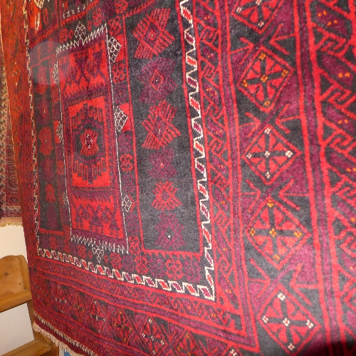 A fine North East Persian Zabul Belouch rug with repeating panel motifs with stylized geometrical