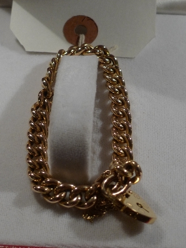 A 9ct gold curb bracelet with padlock