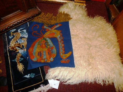 A miniature Chinese silk carpet  decorated with a dragon together with a small  wall hanging