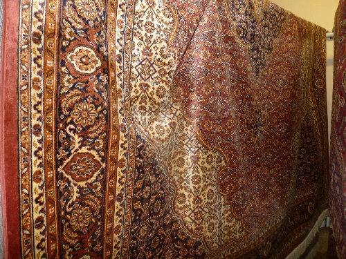 A Persian design Keshan carpet the gold field with extensive foliate decoration within a similar