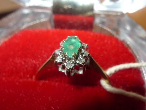 A 9ct gold ladies dress ring with emerald flanked by diamonds