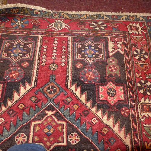 A fine North West Persian Borchalue rug with pendant medallion on a terracotta field within a