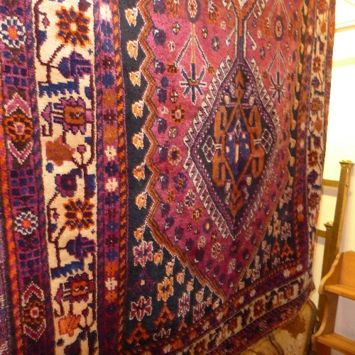 A fine South West Persian Lori rug with triple pole medallion on a brick colour field within