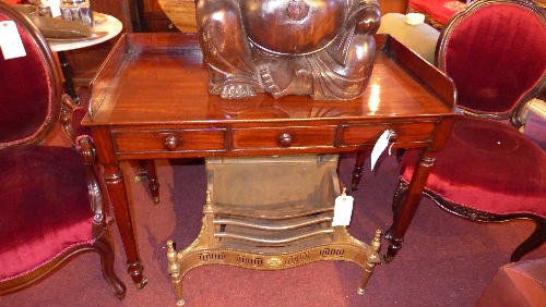 A C19th mahogany writing table the 3/4 gallery top over 2 frieze drawers in turned supports W 107
