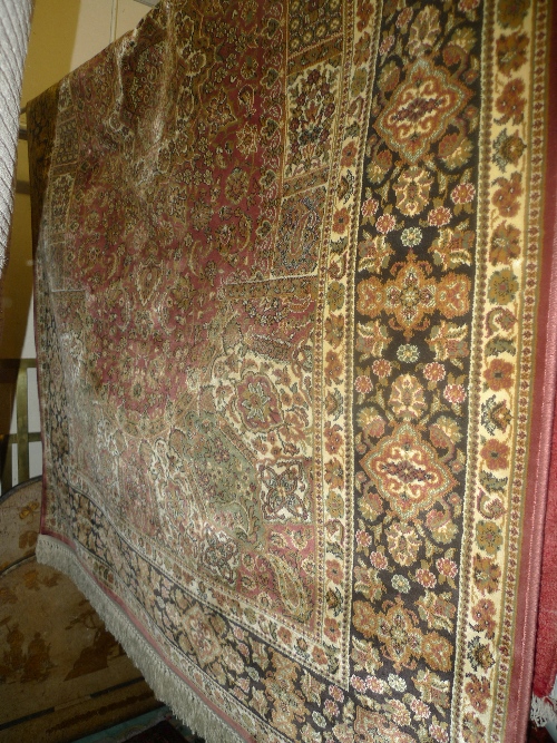 A Persian design Madras carpet the multi coloured field with extensive foliate decoration L 230 x W