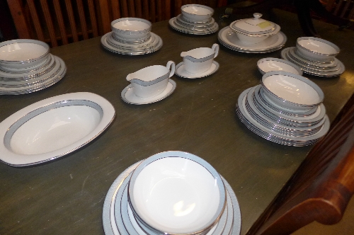 A Royal Doulton `Etude` part dinner service with blue rim trim