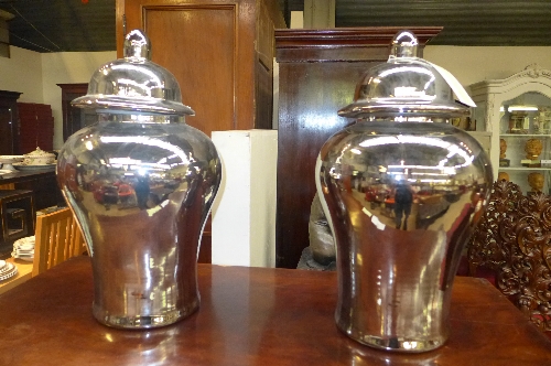 A pair of silvered porcelain temple jars and covers W 32 H 54 cm