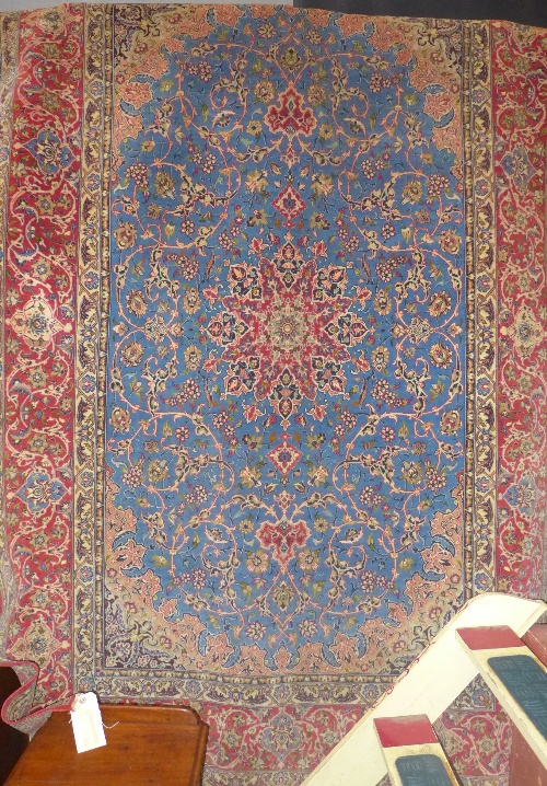 A fine hand knotted part silk Persian Kashan the blue ground with central diamond motif and multi