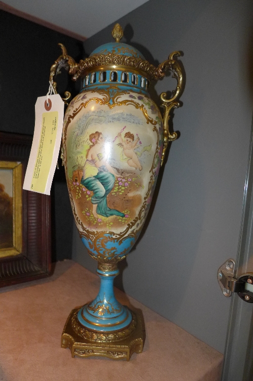 A pair of Serves design bleu celeste ground vases and covers within gilded detail and pictorial