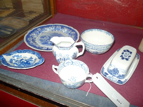 A collection of blue and white items including a late C18th willow pattern dish and others W 9-27