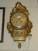 A Continental Cartel gilt wall clock decorated with roses and foliate adornments and pendulum W 34