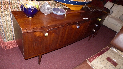 A mahogany `Beautility` sideboard of bowfront outline fitted arrangement of drawers and cupboards