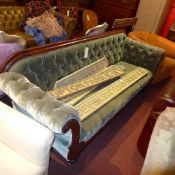 A Victorian mahogany settee with double scroll ends the buttoned upholstery in green velour on