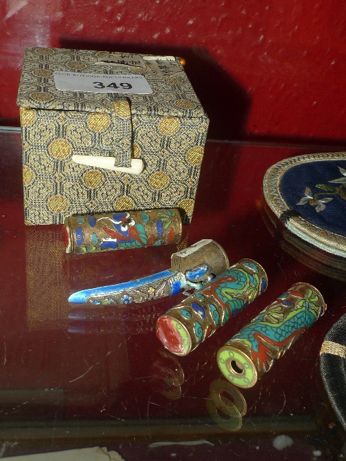 A collection of Chinese items including four silkwork pouches together with three Champleve pieces