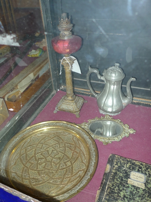 A Victorian brass Corinthian column form lamp with cranberry glass reservoir, a dressing mirror, a